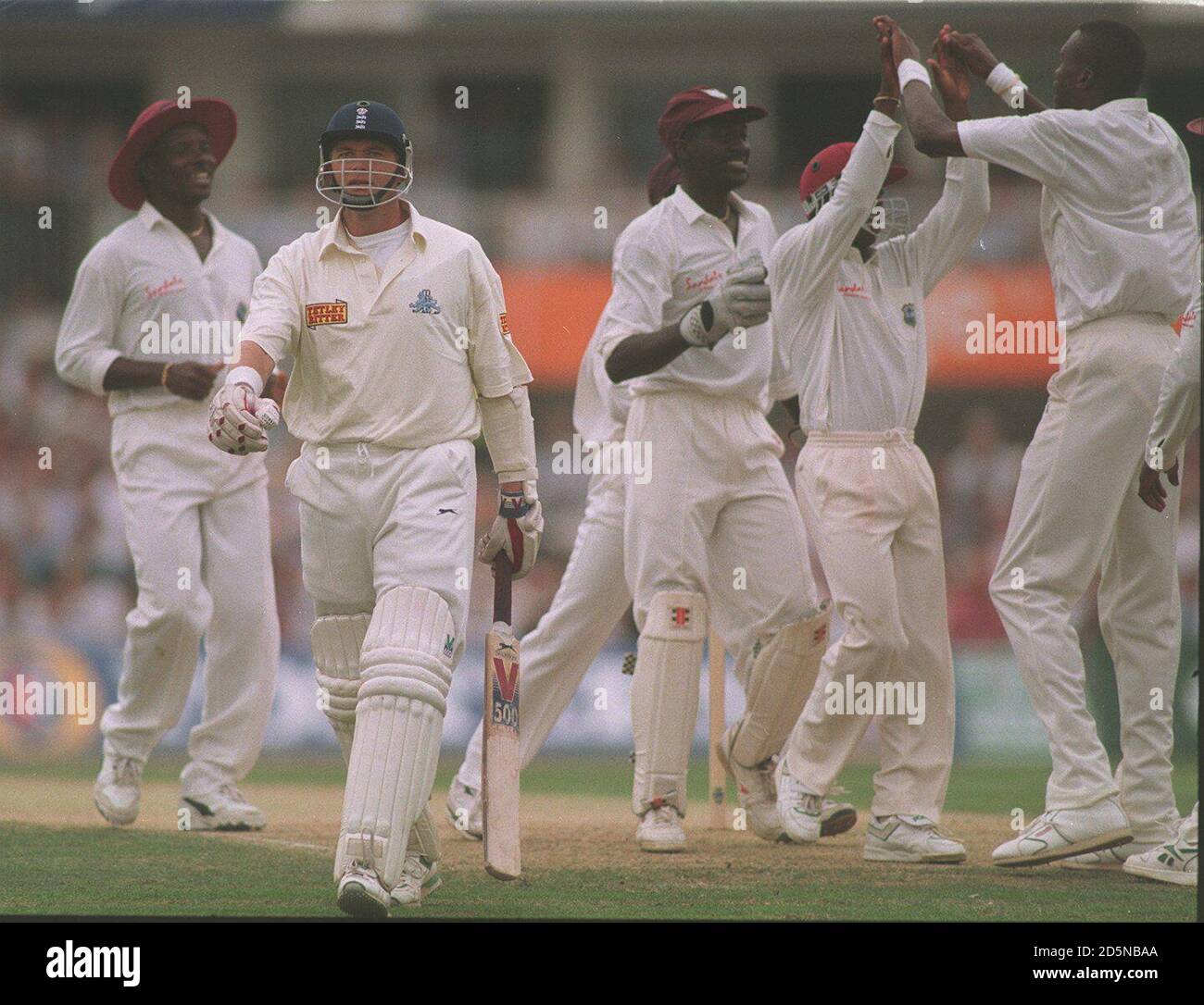 England's Alan Wells is dismissed for a duck on his debut, by West Indies' Curtly Ambrose (right) Stock Photo