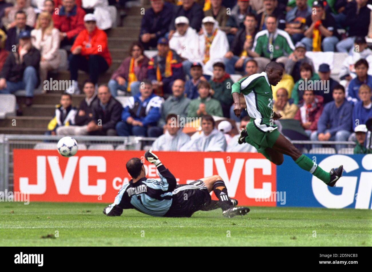 Spain goalkeeper Andoni Zubizarreta (left) tackles Victor Ikpeba of Nigeria (right) Stock Photo