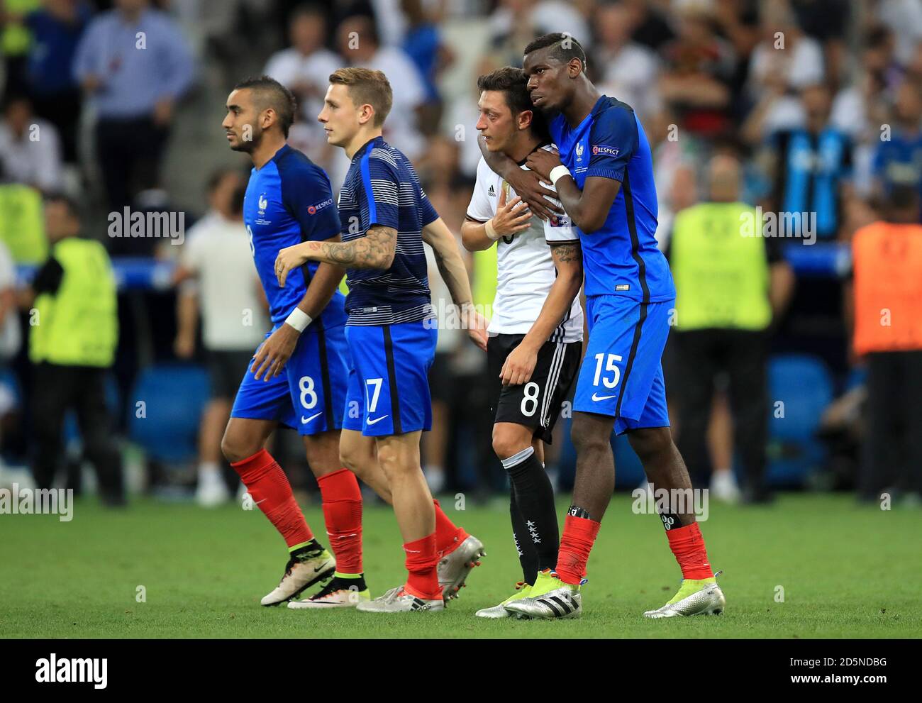 France's Paul Pogba (right) embraces Germany's Mesut Ozil after the ...