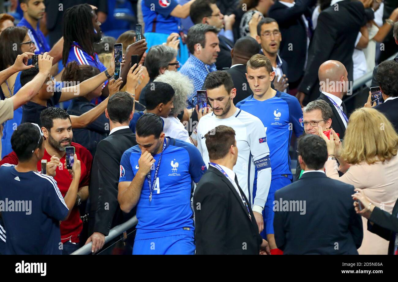 France's Blaise Matuidi and France goalkeeper Hugo Lloris show dejection after collecting their runners up medals after losing to Portugal in the UEFA Euro 2016 final. Stock Photo