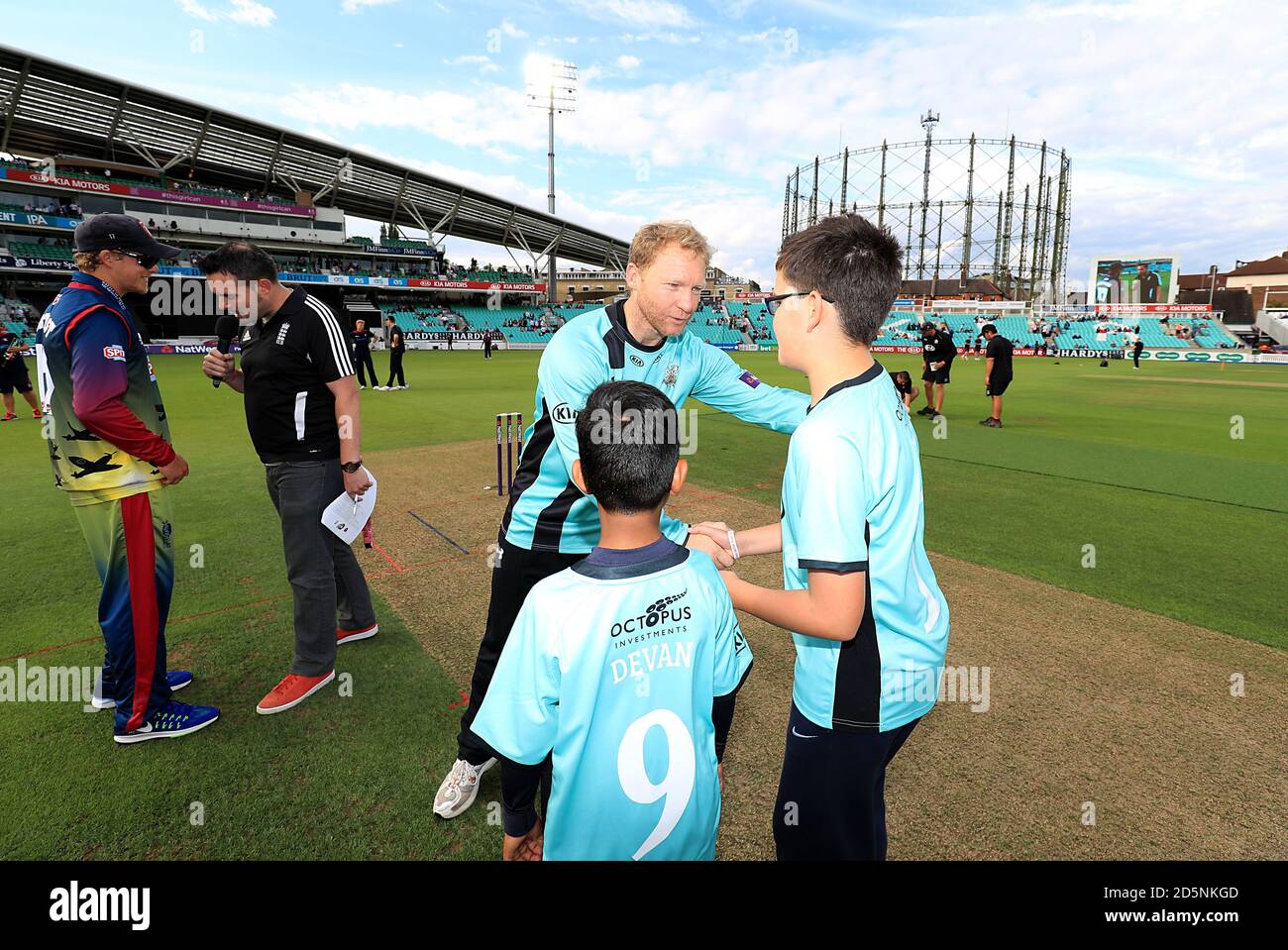Surrey Captain Gareth Batty meets young mascots prior to the match.  Stock Photo