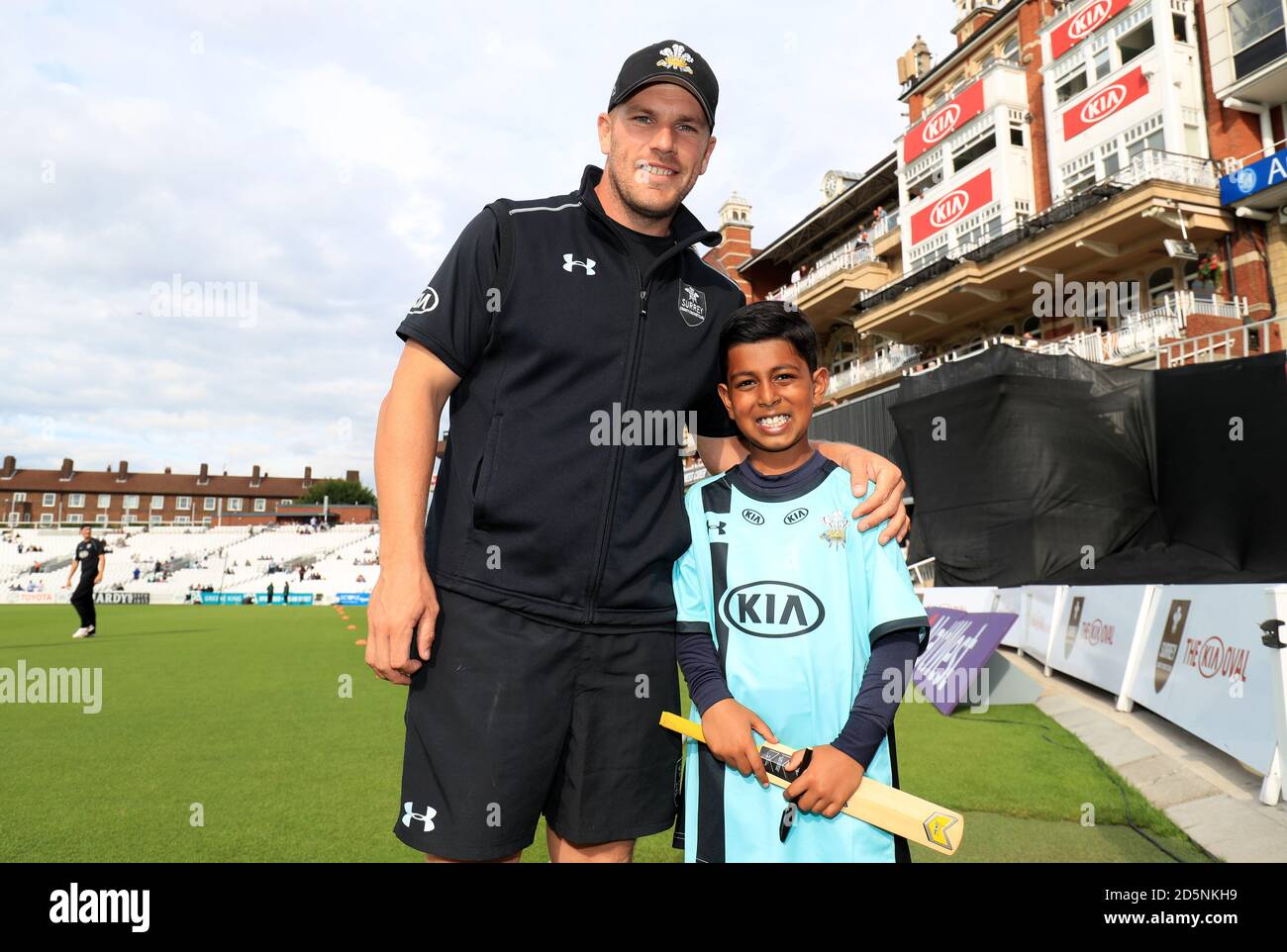 Surrey's Aaron Finch poses with a young mascot prior to the match. Stock Photo