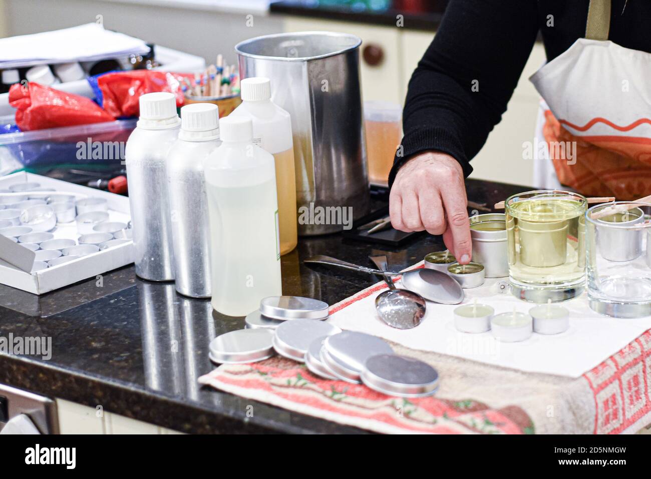 Making candles at home and adding a wick to liquid candle wax Stock ...
