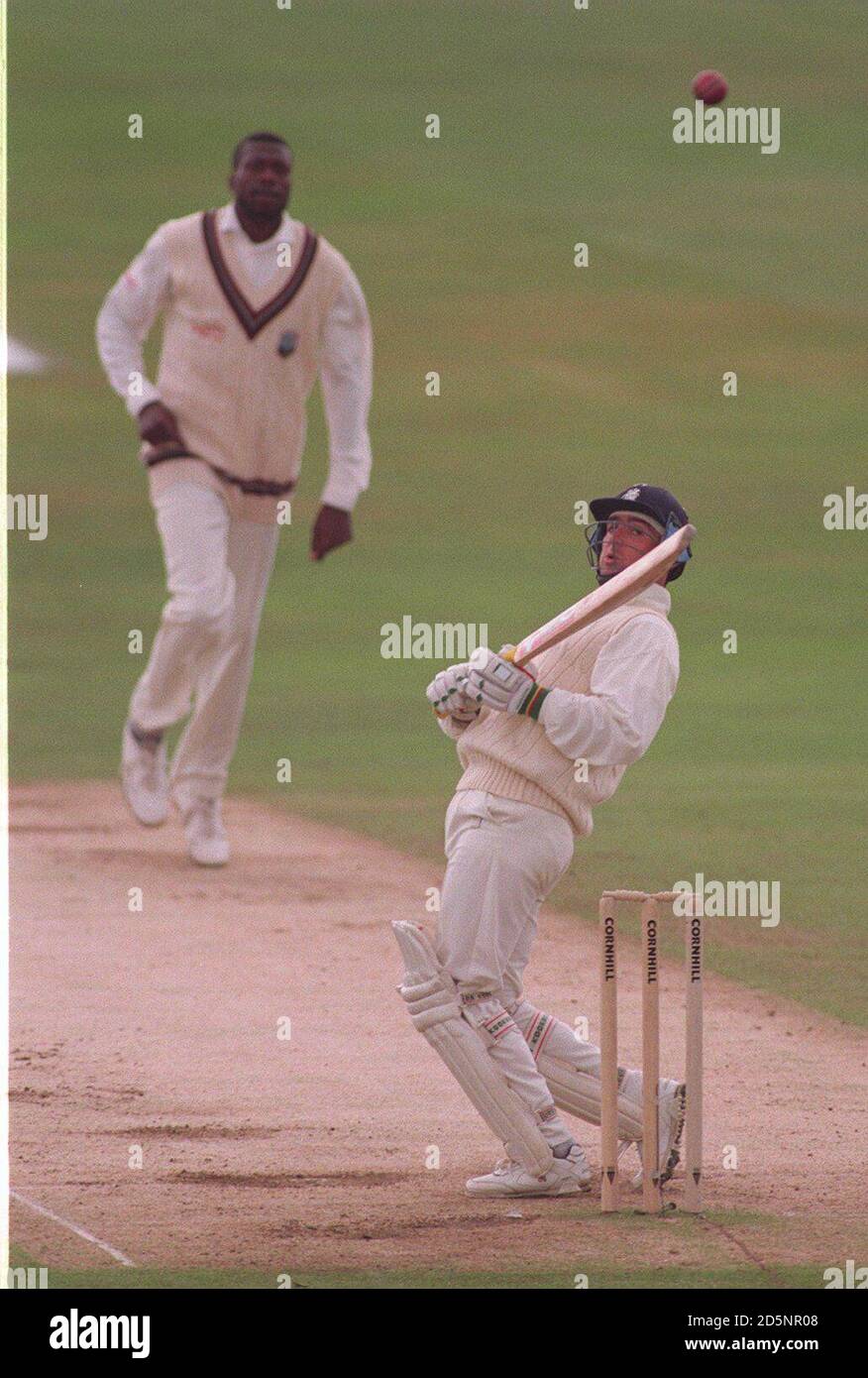 England's Graham Thorpe (right) avoids a bouncer from West Indies' Curtly Ambrose (left) Stock Photo