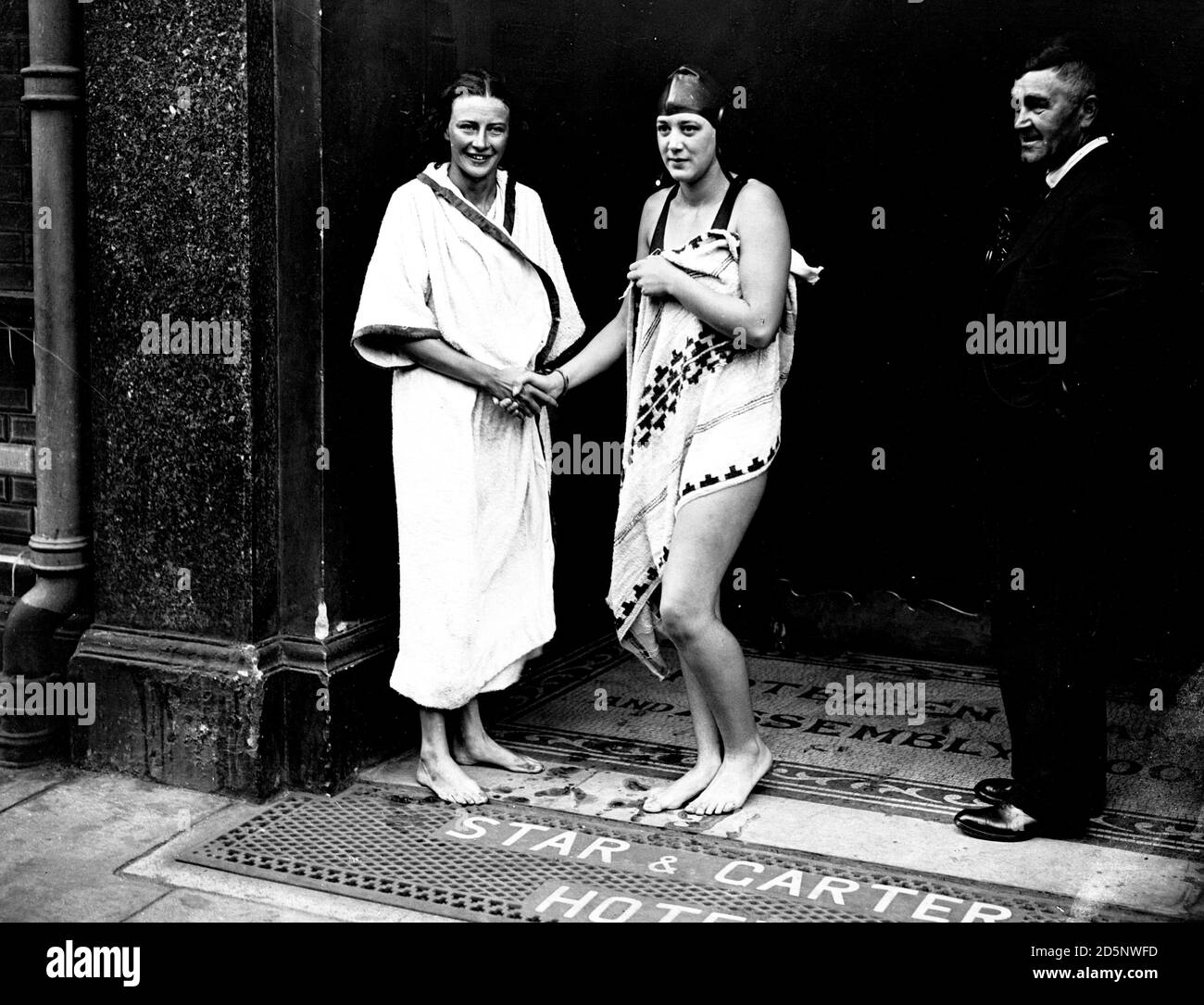Joyce Cooper (l) after she won the Women's Long-Distance Championship swimming race from Kew to Putney in the River Thames. Cooper is being congratulated by last year's winner Miss Gladys Wine Jackman, who was second in this year's race. Stock Photo