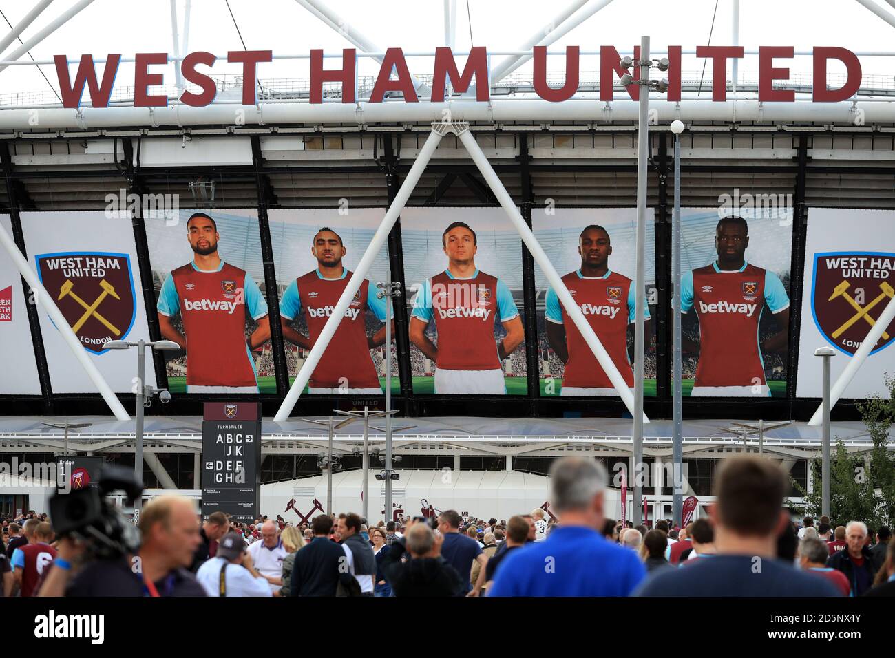 West Ham United supporters make their way to the London Stadium ahead of the game  Stock Photo