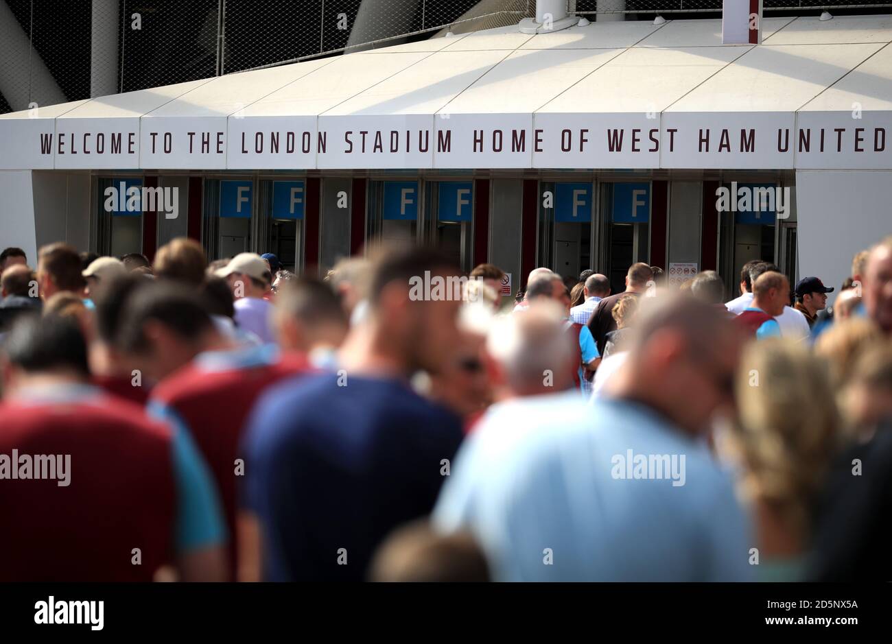 West Ham United supporters make their way to the London Stadium ahead of the game  Stock Photo