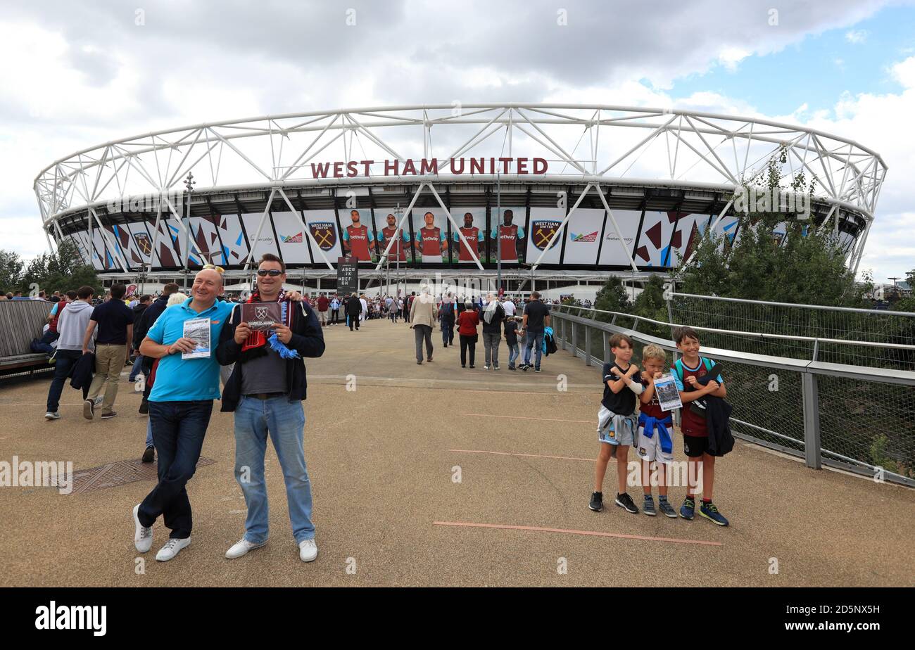West Ham United supporters make their way to the London Stadium ahead of the game  Stock Photo