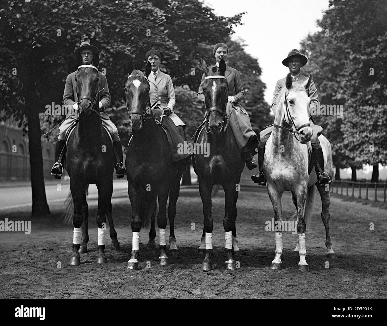 (L-R) Prince Castell of Castell, Mrs von Loebbecke, Mrs Duesing and Count Rothkirch, on their horses while exercising in the Row, Hyde Park, London. Frau Duesing, of Hamburg, Germany, has arrived in London with three other German riders to compete at the International Horse Show at Olympia in London. Stock Photo