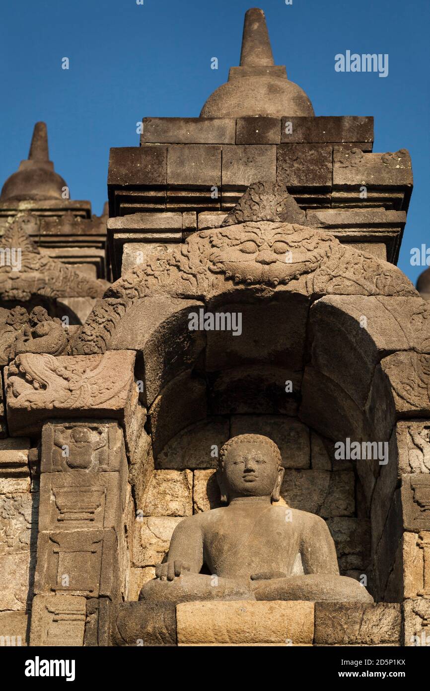 Vertical view of one of the Buddha statues of Borobudur Buddhist Temple ...