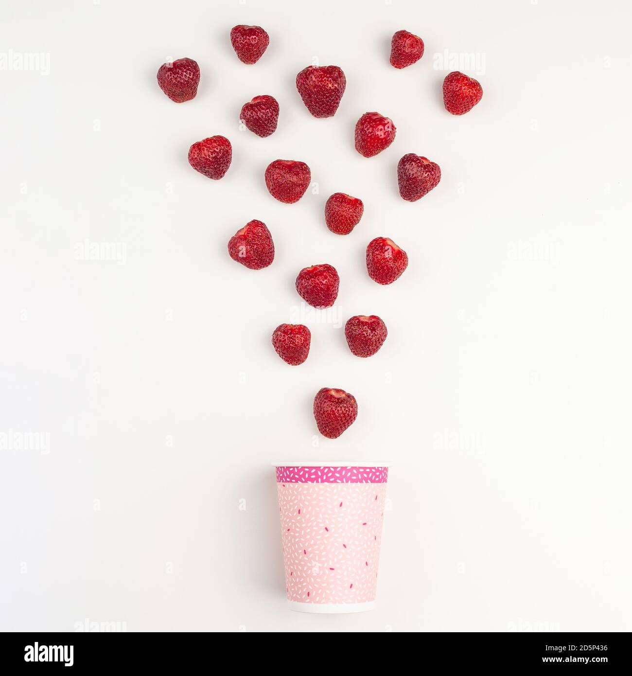 strawberries fall into a paper cup Stock Photo - Alamy