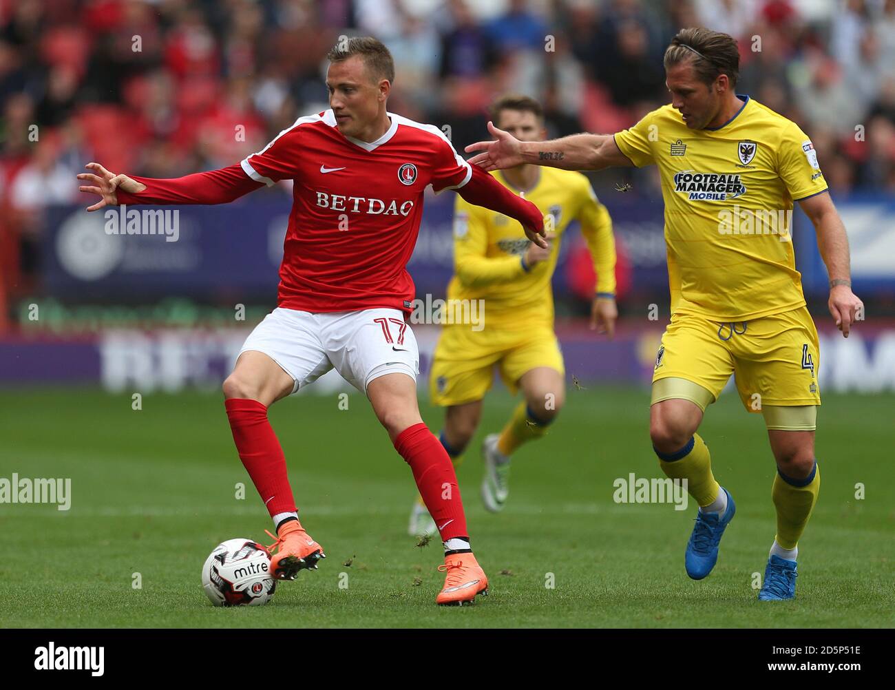 Charlton Athletic's Fredrik Ulvestad (left) and AFC Wimbledon's Dannie Bulman battle for the ball  Stock Photo