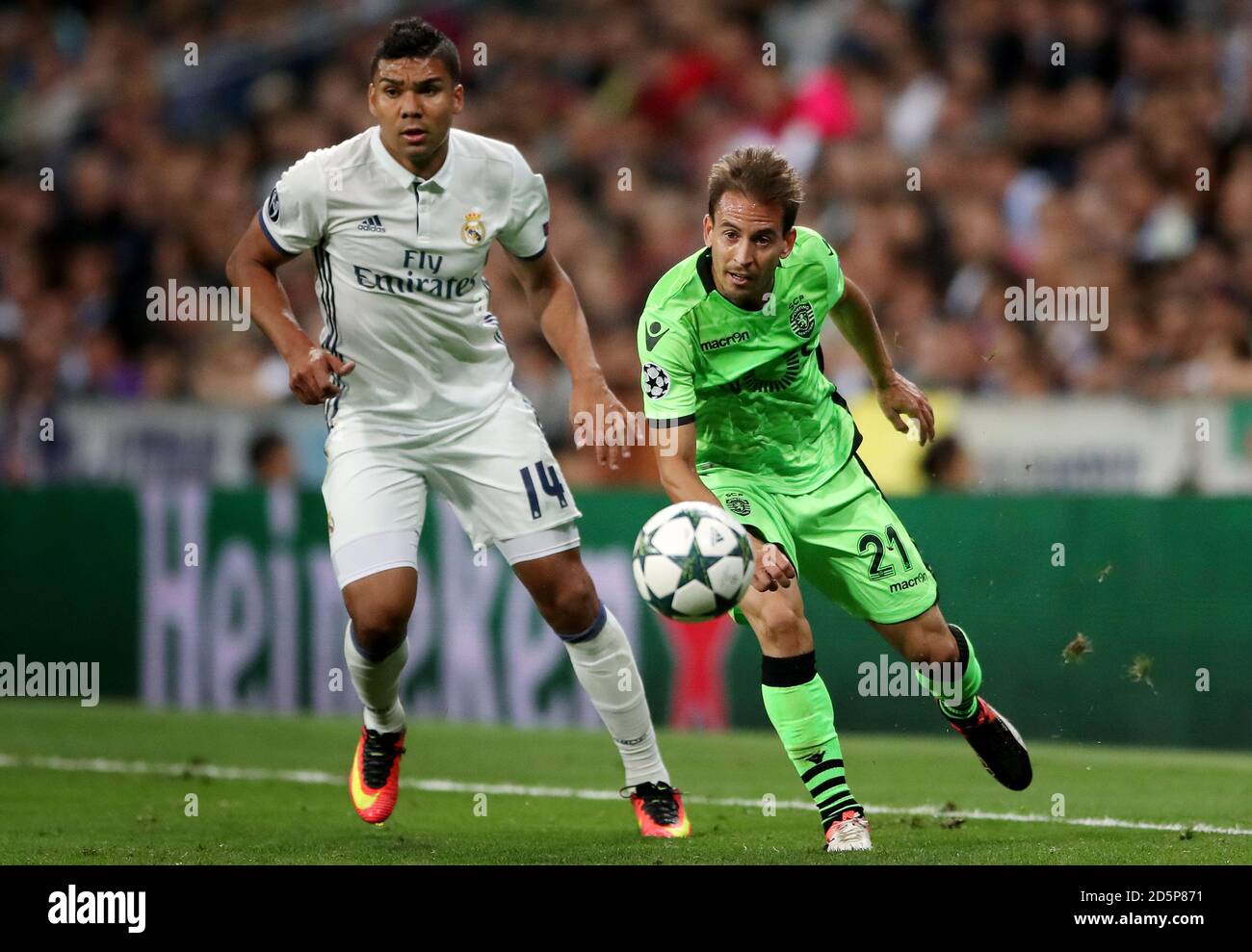 Real Madrid's Casemiro (left) and Sporting Lisbon's Joao Pereira battle for the ball Stock Photo