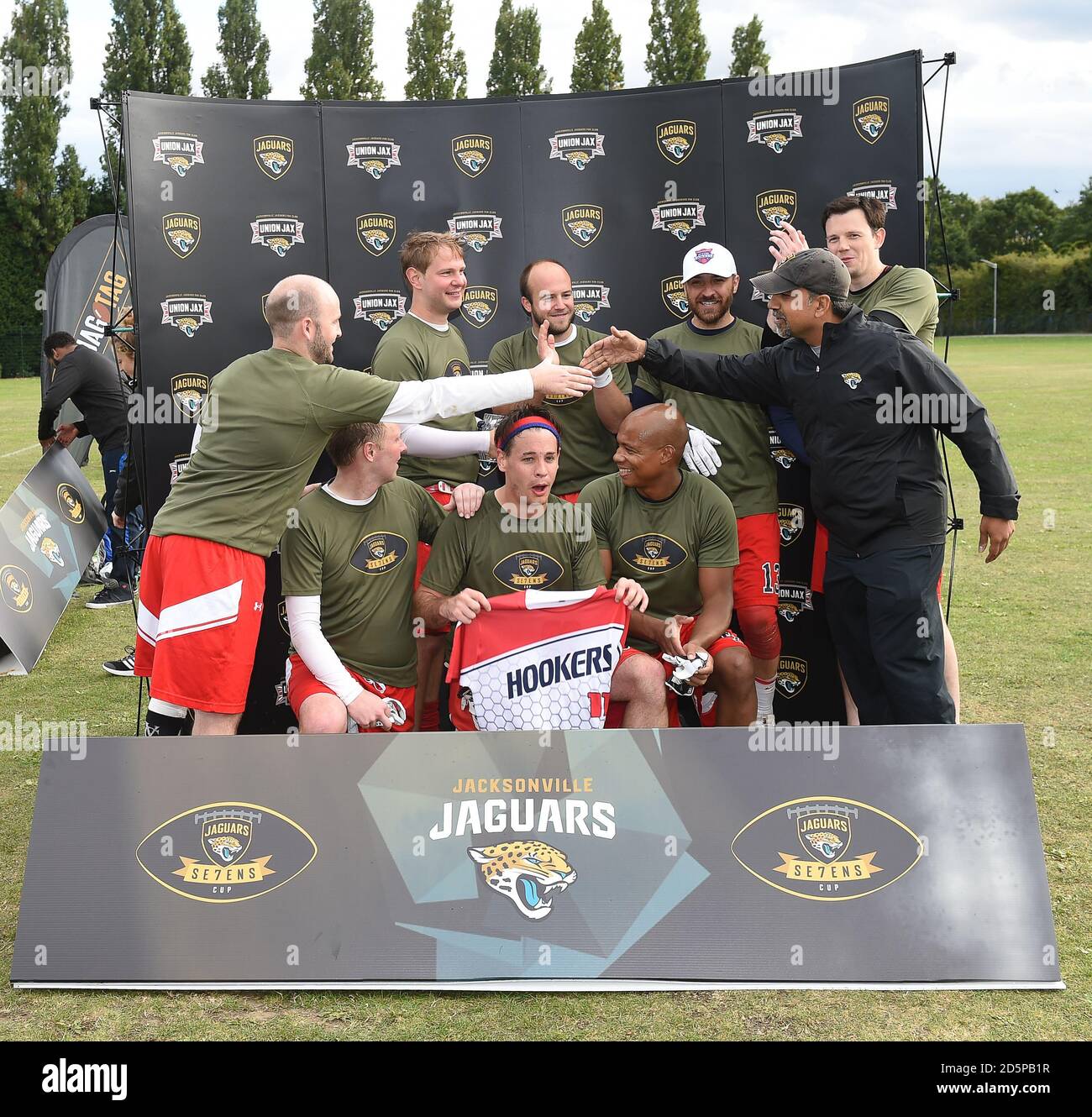 Winners of the Jaguars Se7ens Cup, Baker Street Buttonhookers, are presented with their trophy