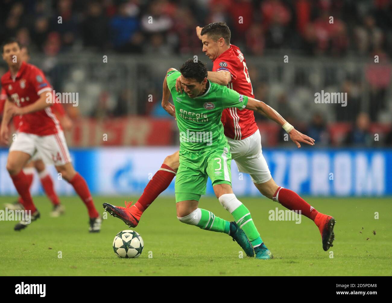 Bayern Munich's Robert Lewandowski and PSV Eindhoven's Hector Moreno battle for the ball Stock Photo