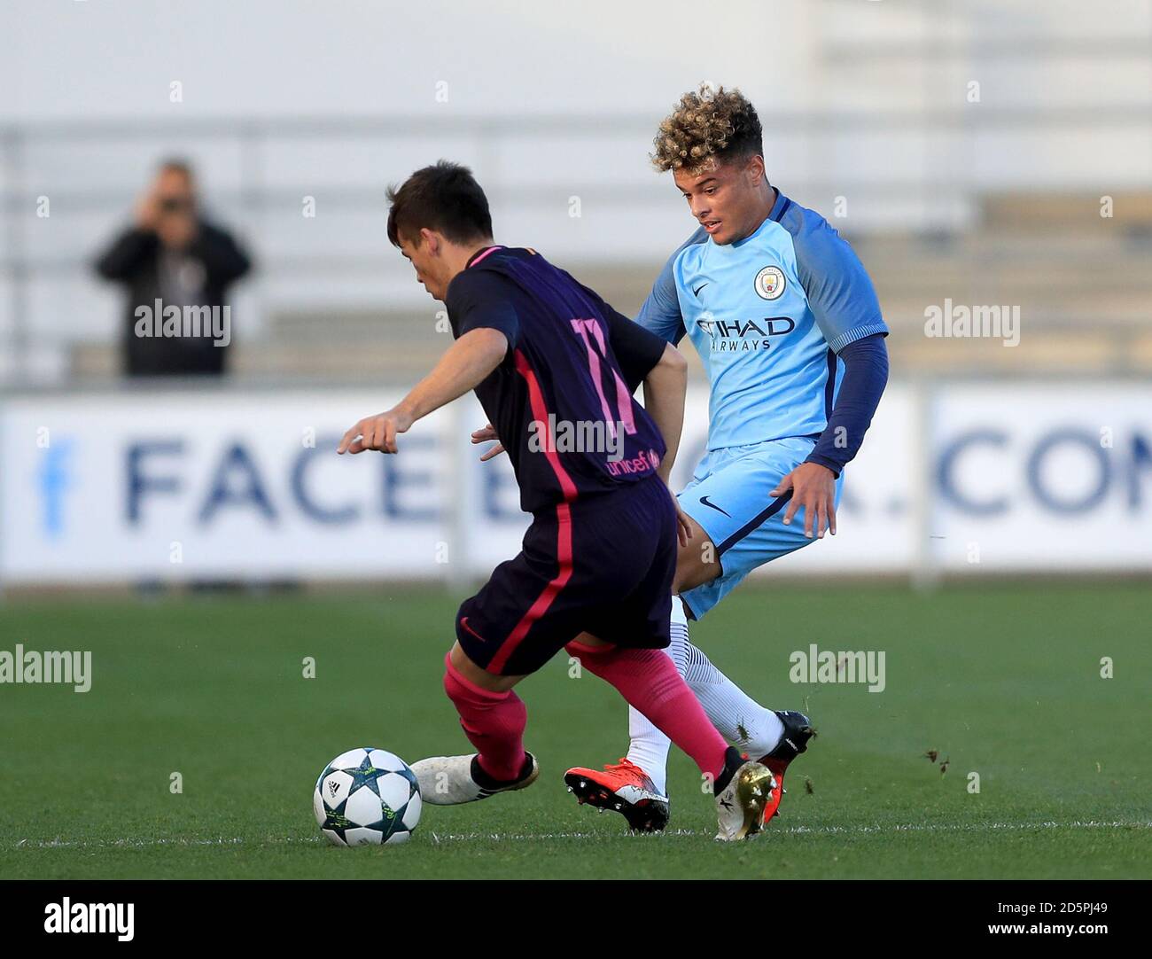 Manchester City's Joel Latibeaudiere and Barcelona's Carles Perez battle for the ball Stock Photo