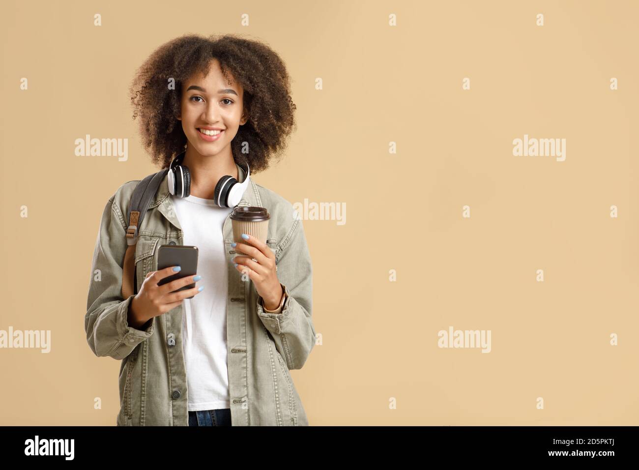 Casual style, fashion, lifestyle and mobile technology. Smiling african american woman texting on smartphone Stock Photo