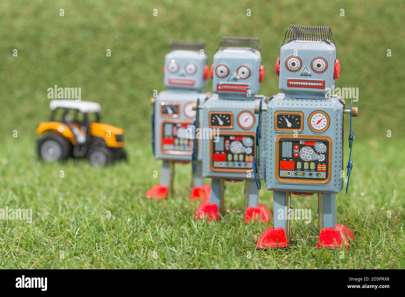 Wind-up clockwork toy robot on fake grass. For troll farm, Russian bots meddling in US American election, Russia trolls & bots, trolling, advances AI Stock Photo