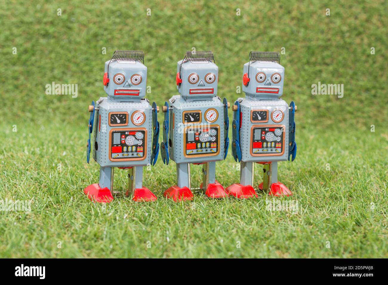 Wind-up clockwork toy robot on fake grass. For troll farm, Russian bots meddling in US American election, Russia trolls & bots, trolling, advances AI Stock Photo