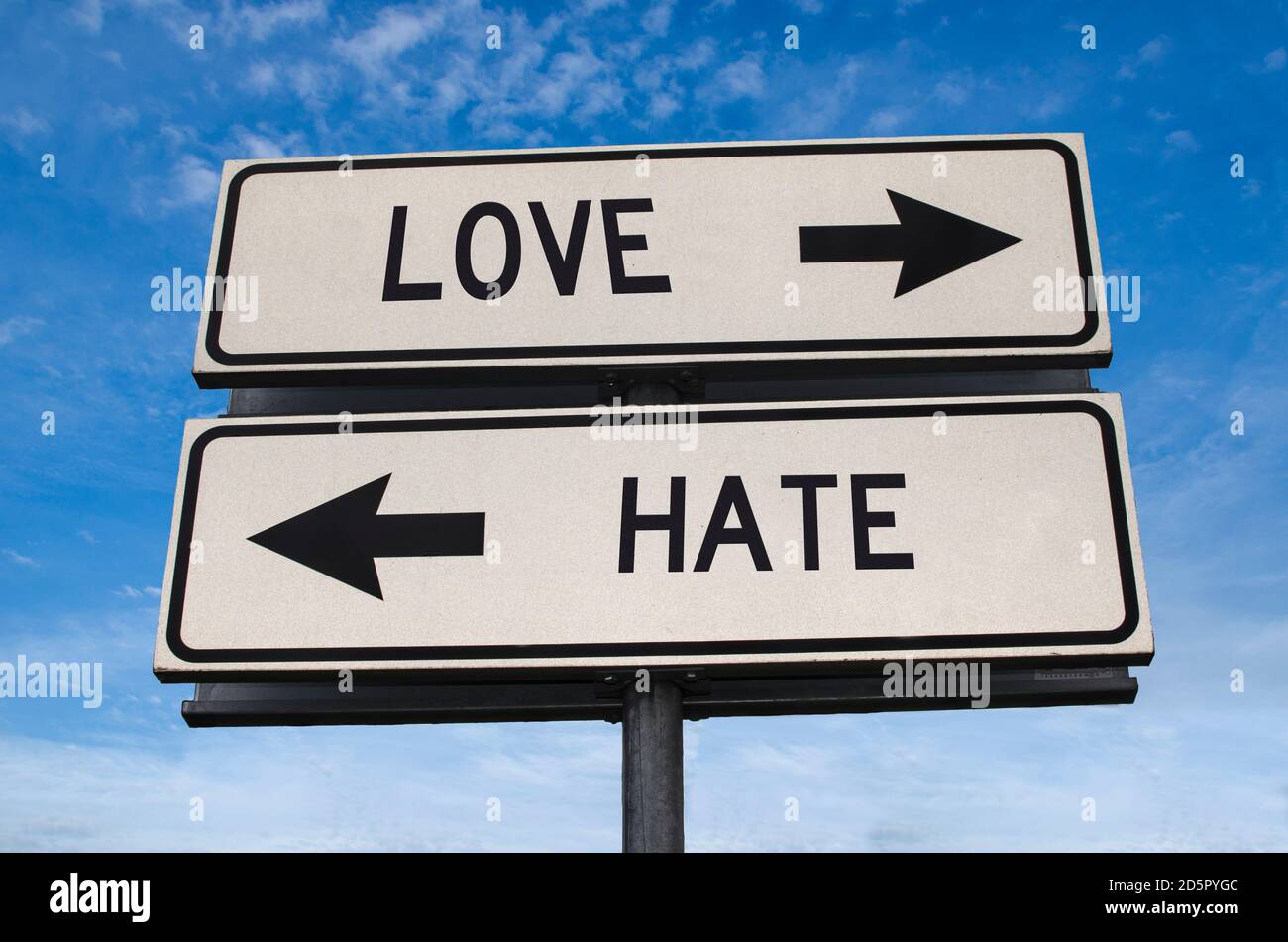 Love versus hate road sign. White two street signs with arrow on metal pole with word. Directional road. Crossroads Road Sign, Two Arrow. Blue sky bac Stock Photo