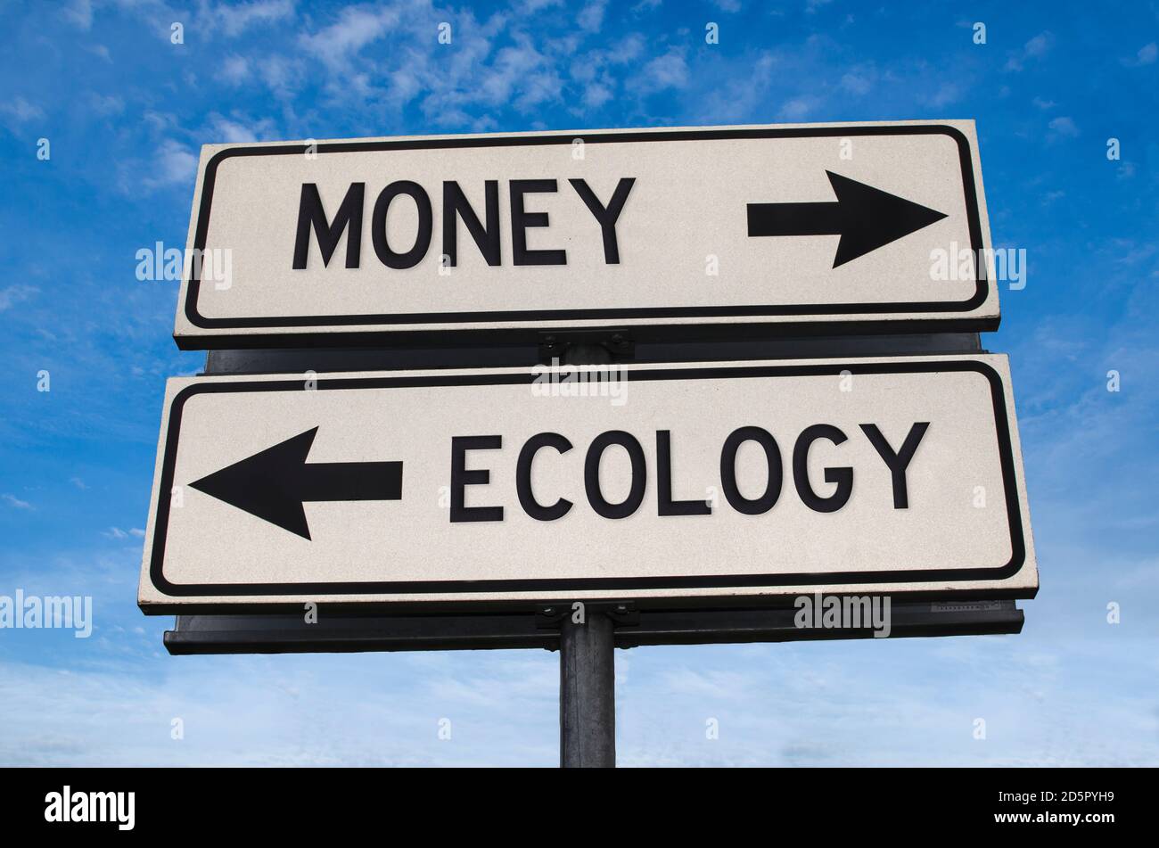 Money vs ecology. White two street signs with arrow on metal pole with word. Directional road. Crossroads Road Sign, Two Arrow. Blue sky background. Stock Photo