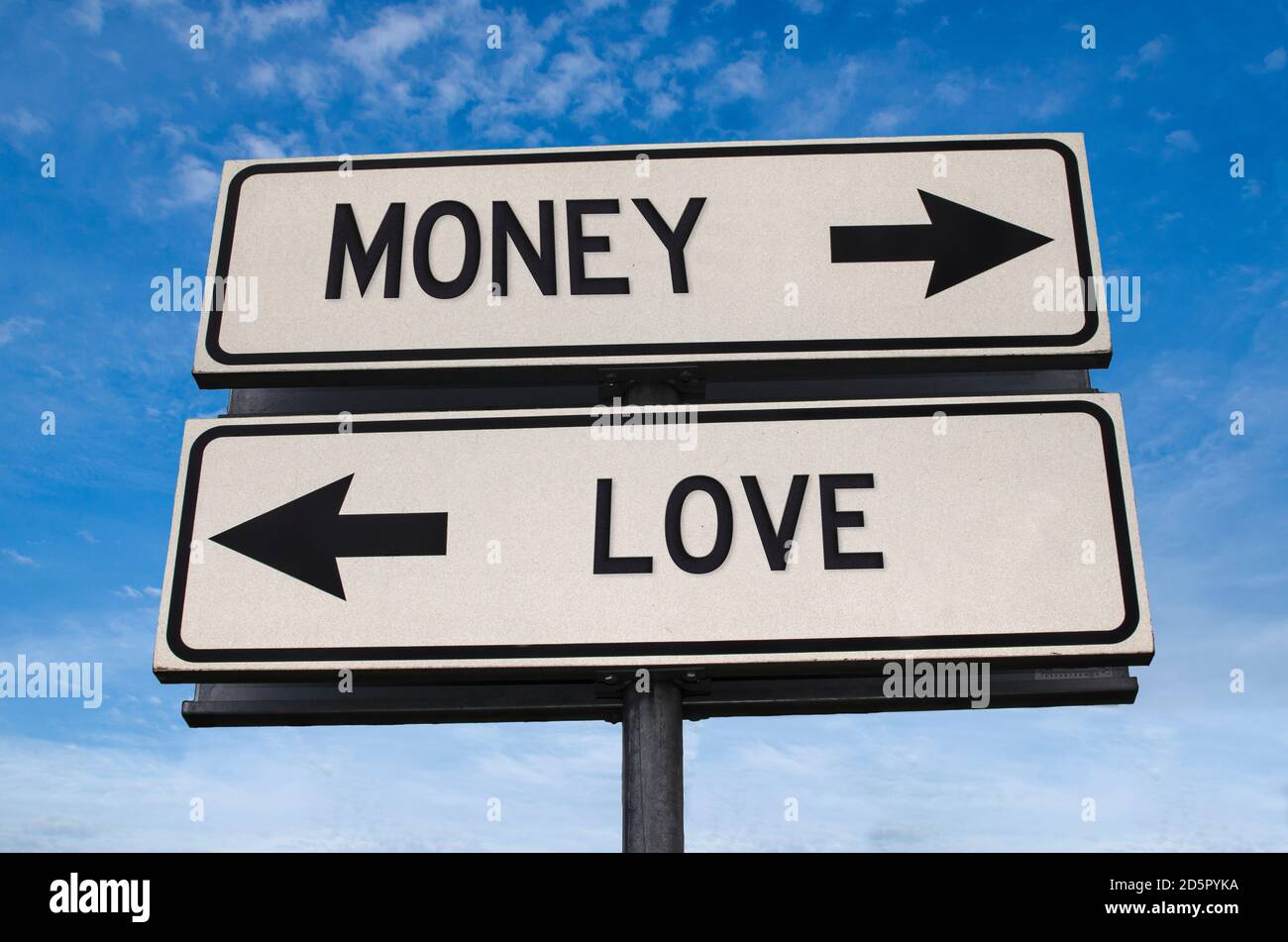 Money vs love. White two street signs with arrow on metal pole with word. Directional road. Crossroads Road Sign, Two Arrow. Blue sky background. Two Stock Photo
