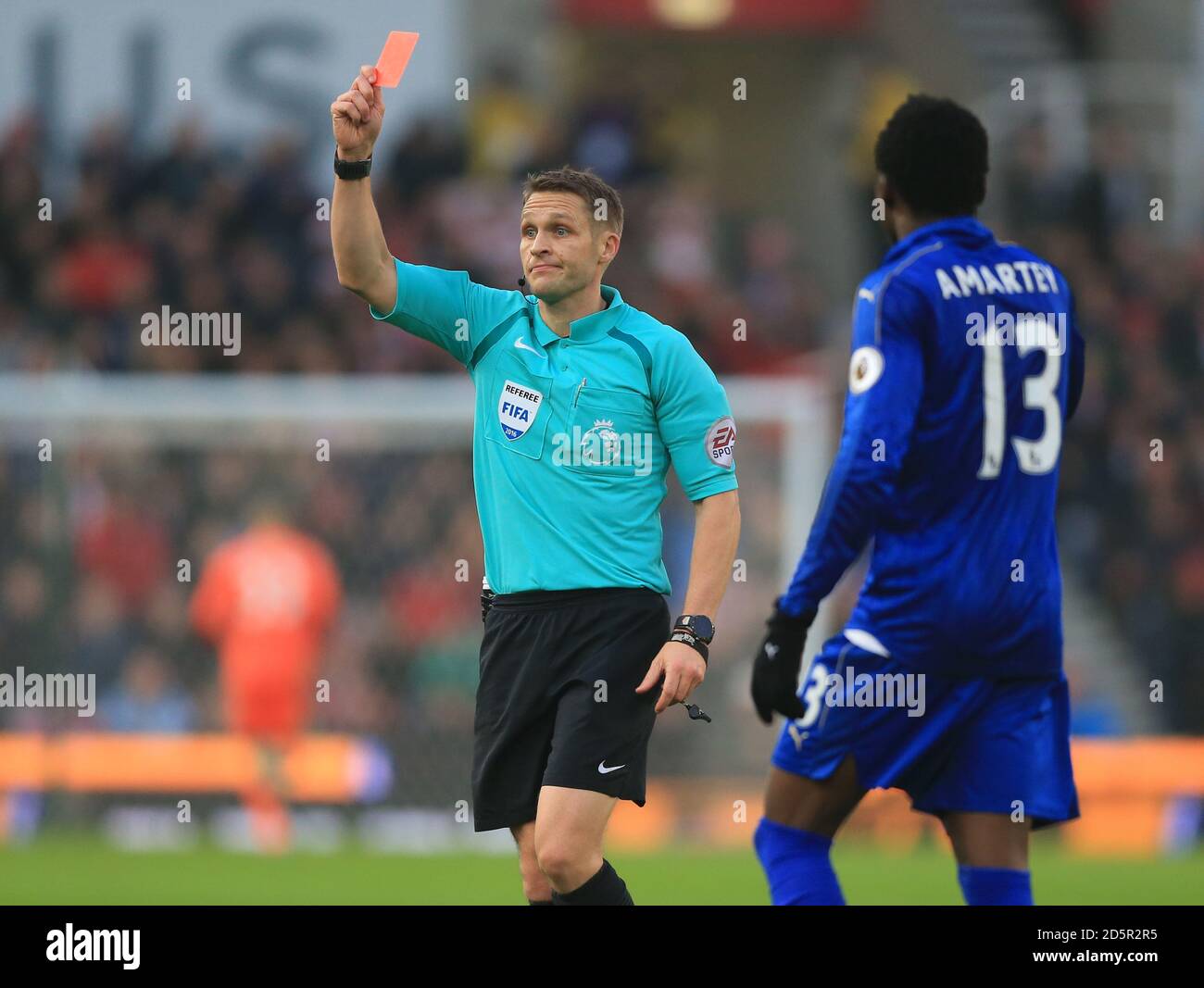 Referee Craig Pawson shows Leicester City's Jamie Vardy (out of picture) a red Stock Photo - Alamy