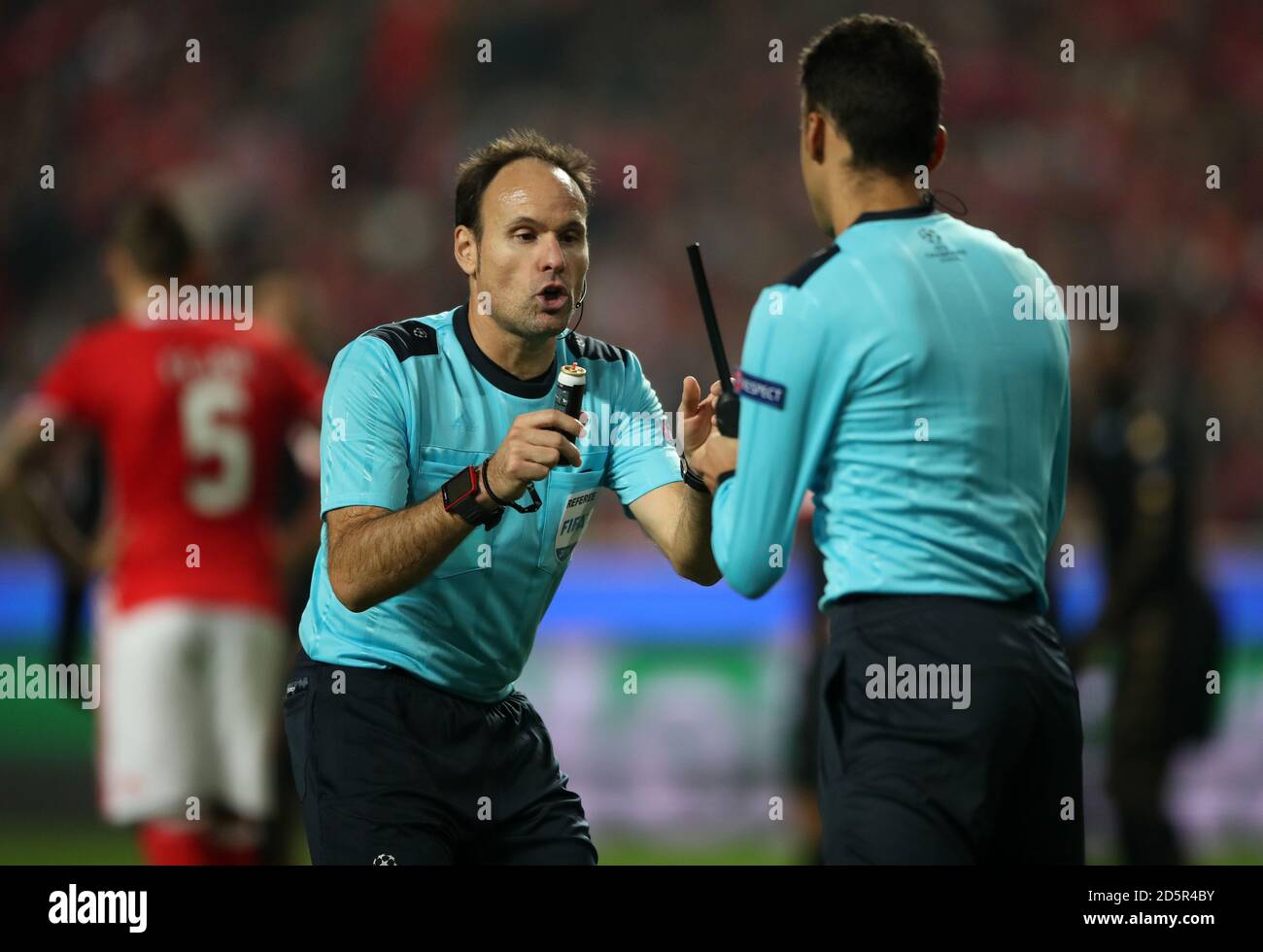 Match referee Antonio Miguel Mateu Lahoz swaps his foam spray with an assistants Stock Photo