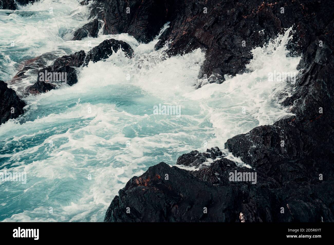 Waves crashing on shore Stock Photo