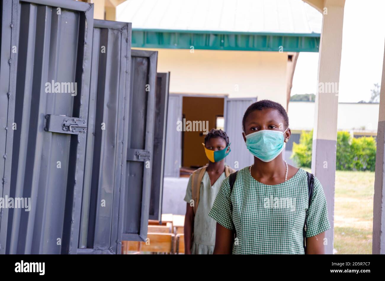 two young african students wearing face mask to prevent them from the ...