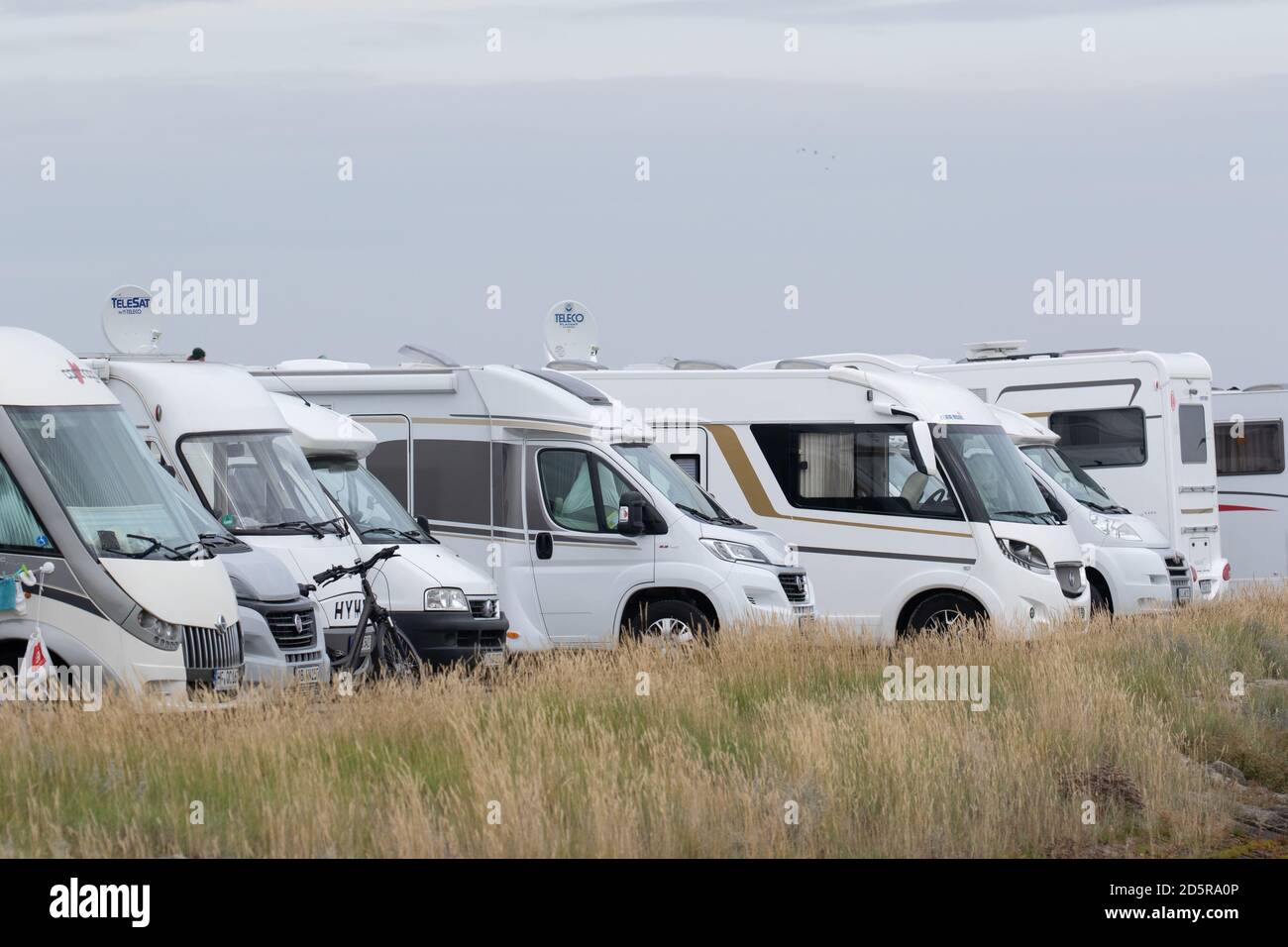 A line of parked Camper Vans, Motorhomes. East Frisia, Lower Saxony. Germany. October 2020 Stock Photo