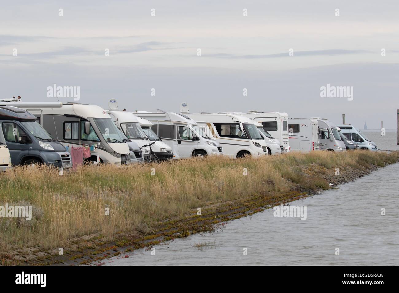 A line of parked Camper Vans, Motorhomes. East Frisia, Lower Saxony. Germany. October 2020 Stock Photo