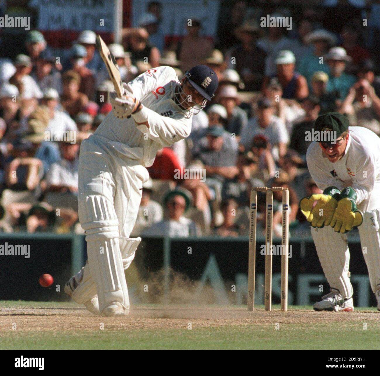 England's Mark Butcher drives in front of Australia's wicket keeper Ian ...