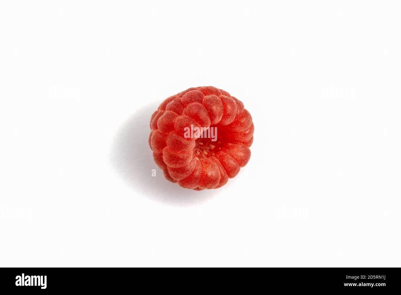 Ripe raspberry isolated on white background close-up. Fresh raspberries without sheets on the table. Macro shooting. Healthy, wholesome food. Top view Stock Photo