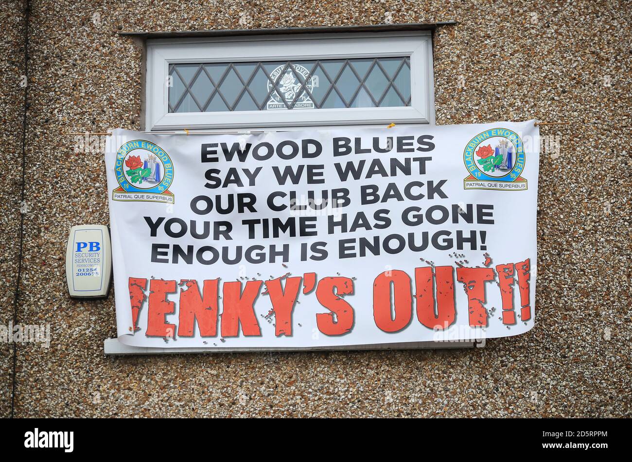 A 'Venky's Out' banner aimed at the Blackburn Rovers owners hangs from a window outside the ground Stock Photo