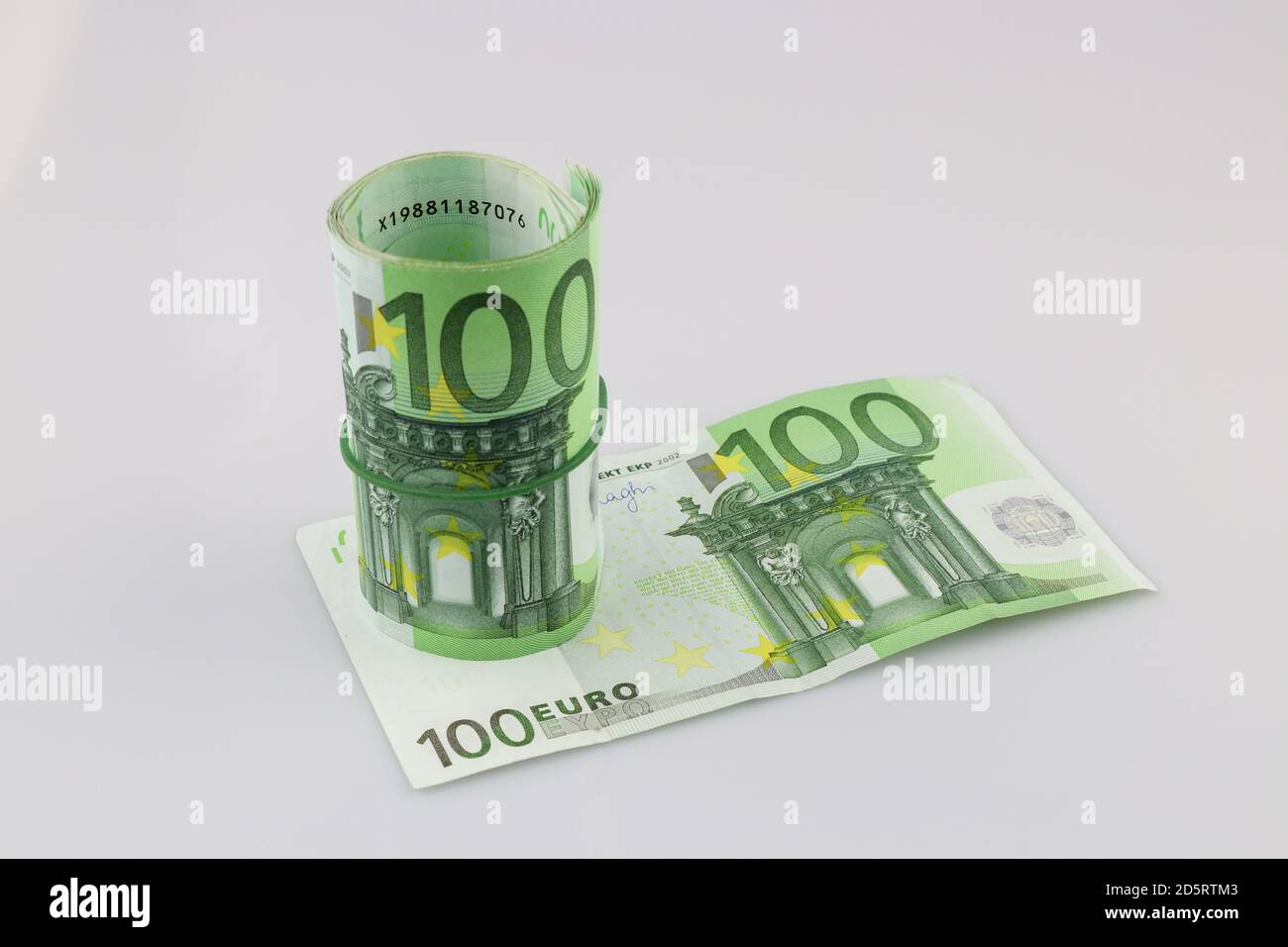 Roll of one hundred euro banknotes with a rubber band, isolated ...