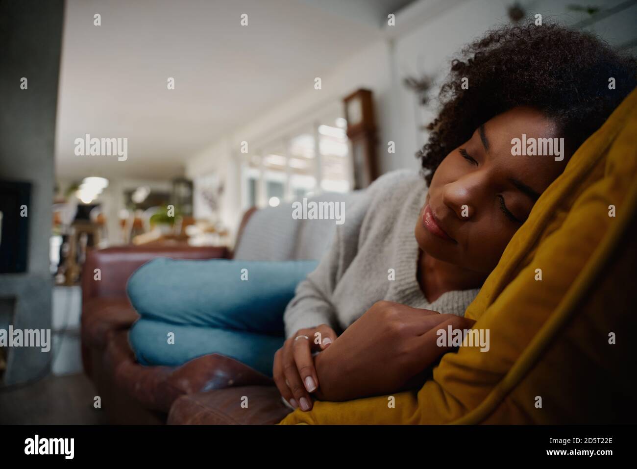 Tired african woman sleeping cozy on comfortable sofa at home Stock Photo