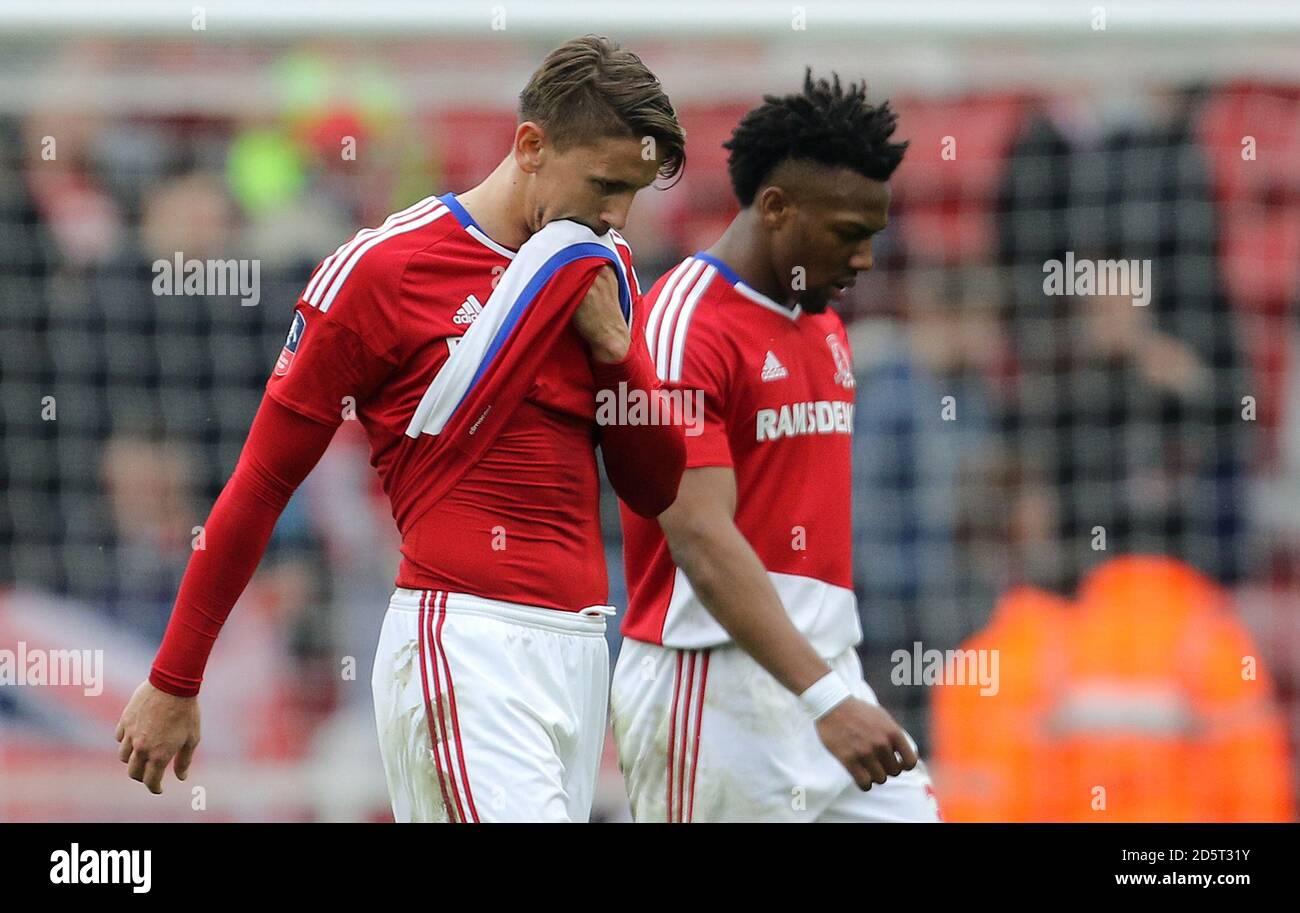 Middlesbrough's Gaston Ramirez (left) and Adama Traore walk off the pitch dejected after the game Stock Photo