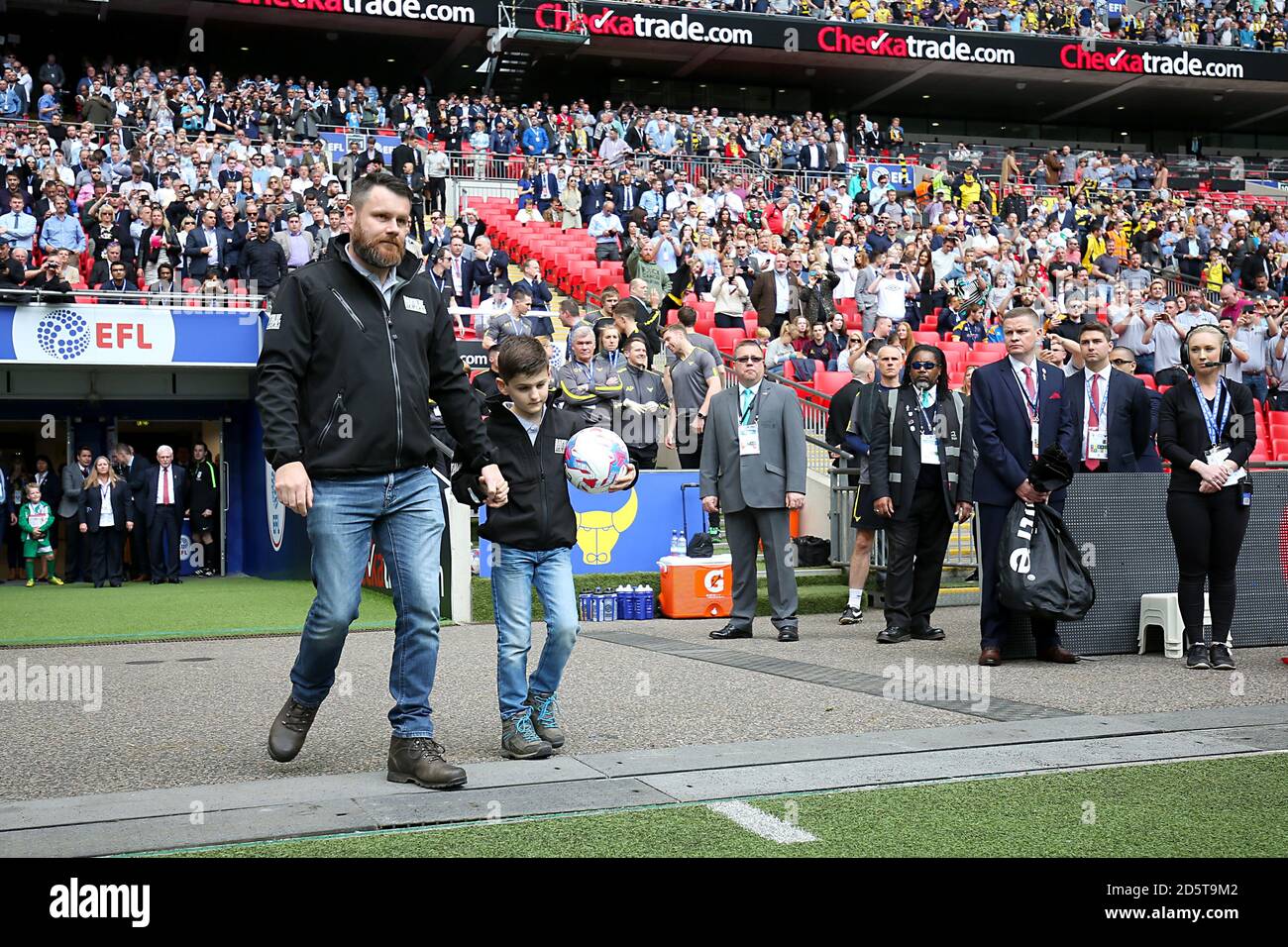 Ball carrier Adam Smith of Band of Builders walking out the match ball in memory of Mr Keith Ellick Stock Photo