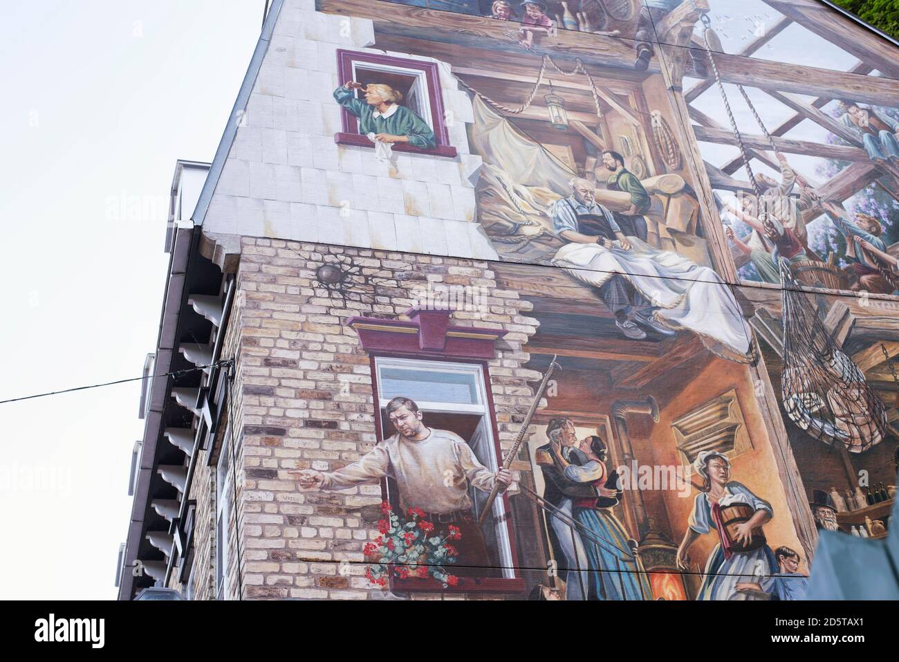 Quebec, Canada.  July 7, 2019. A historic mural fresque du petit champlain depicting life at the the turn of the century in the old port area quebec Stock Photo