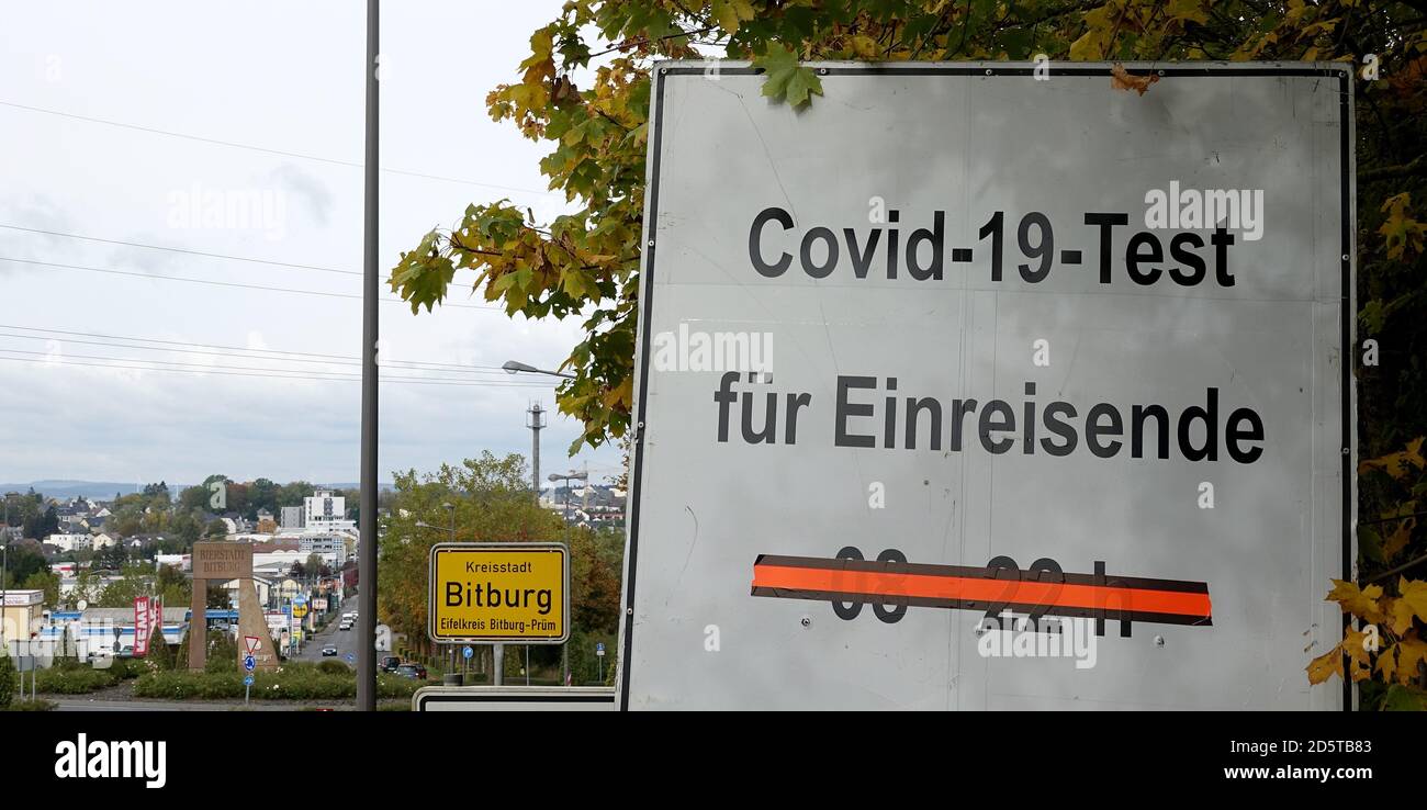 Bitburg, Germany. 14th Oct, 2020. A Covid-19 test signpost in front of the town sign of Bitburg in the Eifel district Bitburg-Prüm. The district is one of the currently most affected districts nationwide with Covid-19 diseases in the past days. Credit: Harald Tittel/dpa/Alamy Live News Stock Photo