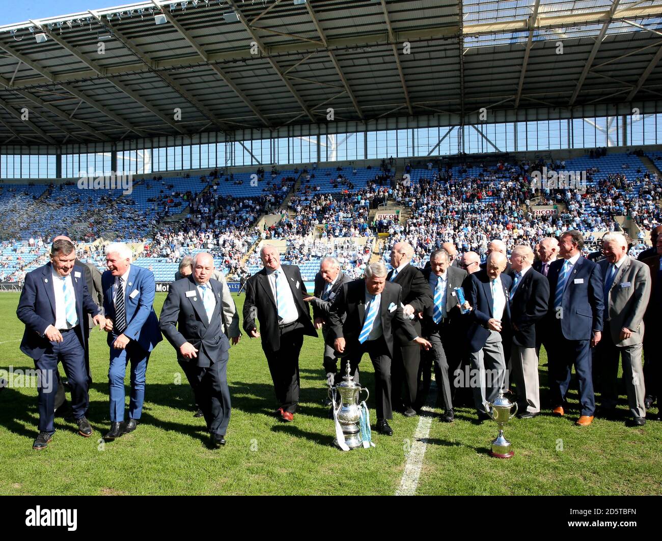Coventry City's legends are caught out by the sprinklers Stock Photo