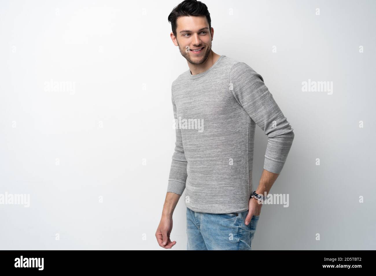 Handsome young man on white background looking at camera. Happy guy ...