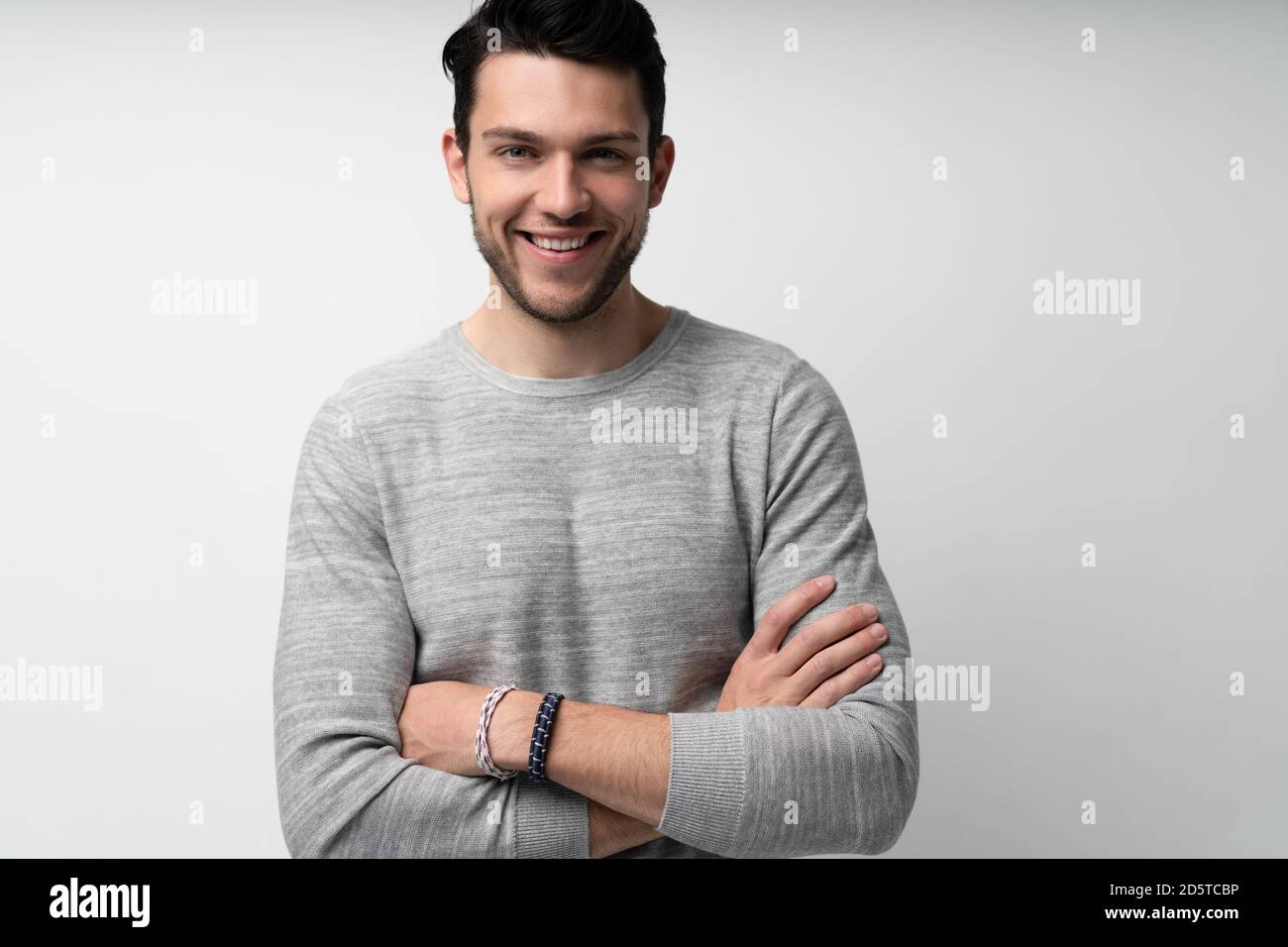 Handsome young man on white background looking at camera. Happy guy ...