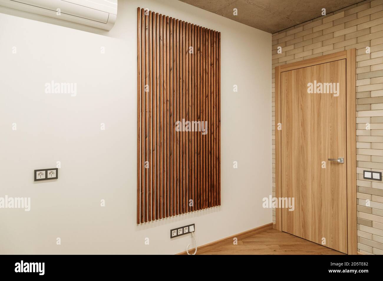 background white wall with brown wooden planks and air conditioner