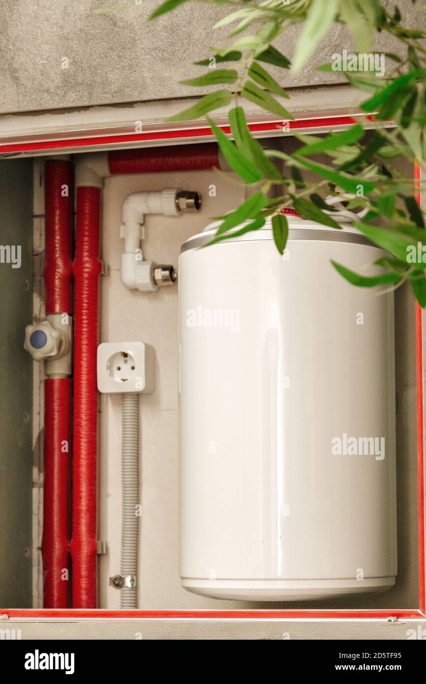 bathroom boiler with pipes and fittings Stock Photo