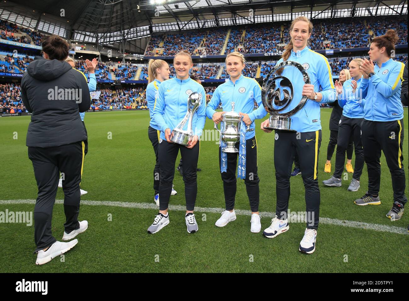 Manchester City's Georgia Stanway (L - R), Manchester City's Izzy Christiansen and Manchester City's Karen Bardsley with the FA WSL Cup, SSE FA Cup final and FA WSL Continental Cup Stock Photo