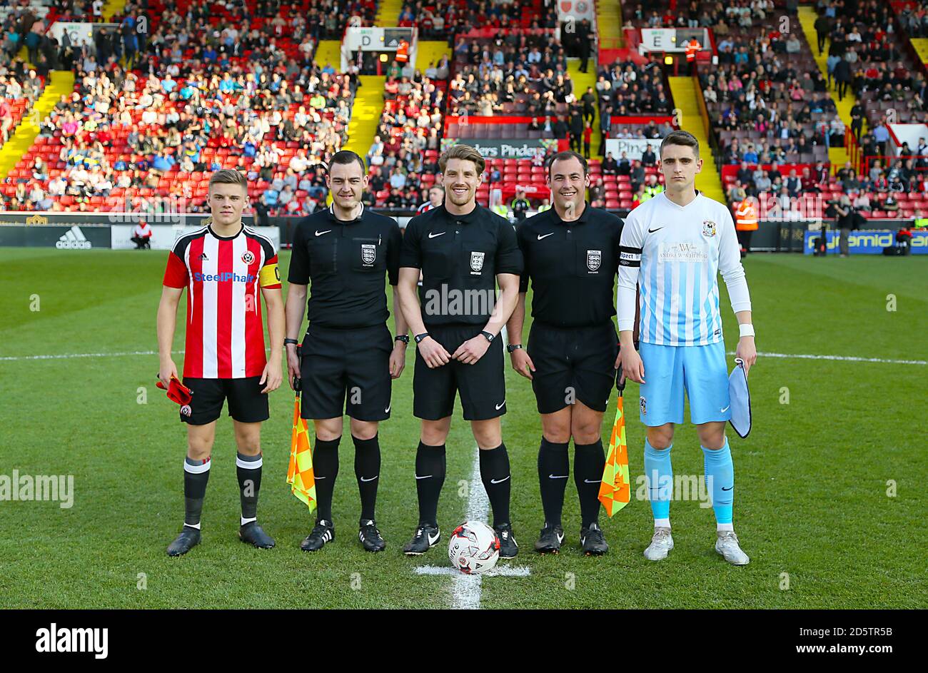 Sheffield United captain Regan Slater (left) and Coventry City captain Tom Bayliss (right) pose for a photograph with officials Sam Mulhall, Jack Forder and Benjamin Stott  Stock Photo