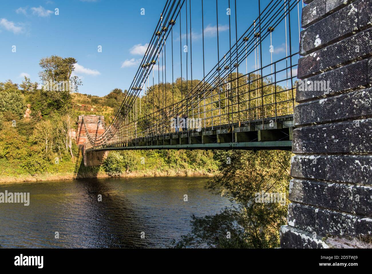 Union Bridge, a 200 year old chain bridge, spans the River Tweed, bridges the borders of England and Scotland. Stock Photo