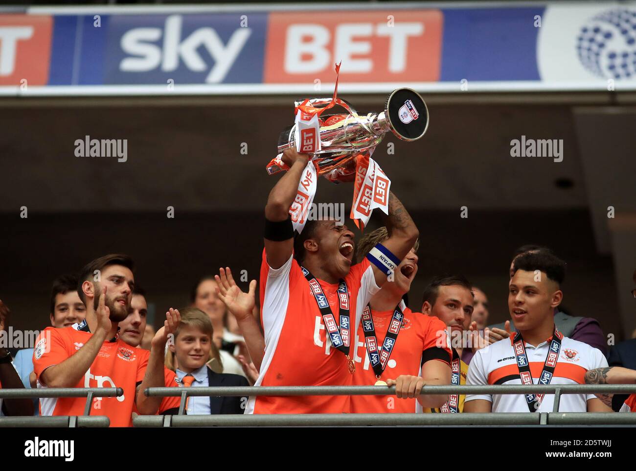 Blackpool's Neil Danns lifts the trophy after the final whistle Stock